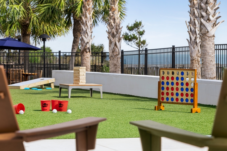 Currents Seaside Entertainment activity lawn with giant Jenga, giant connect four, and other lawn games.