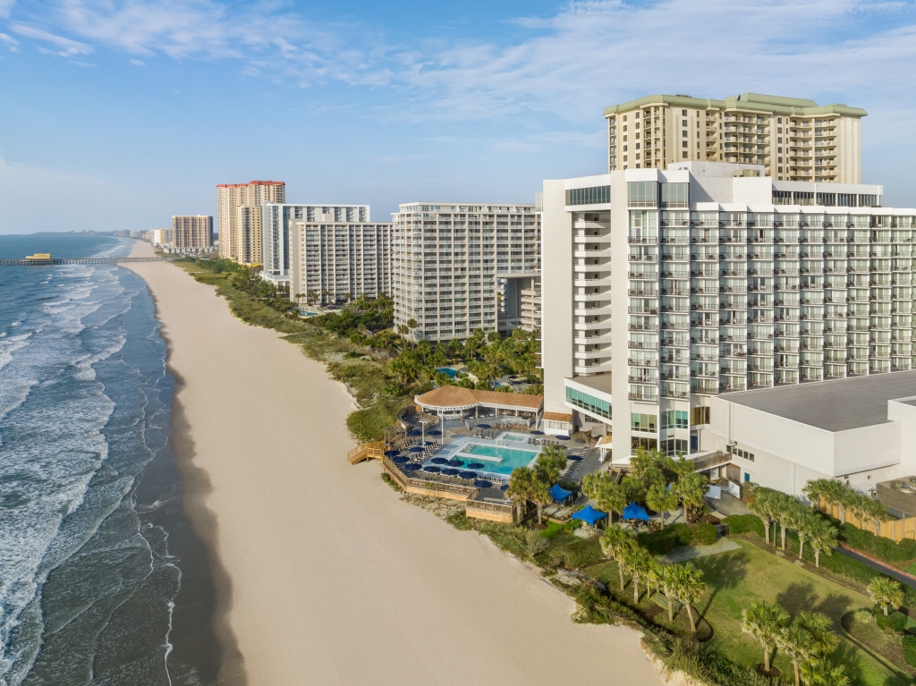 Multiple large hotel buildings on the beach.