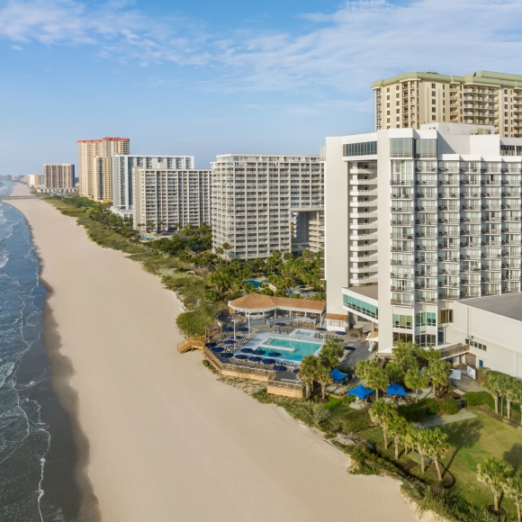 Multiple large hotel buildings on the beach.