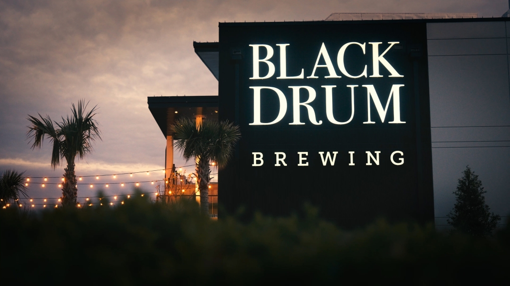 Black Drum Brewing exterior at night with the lights on