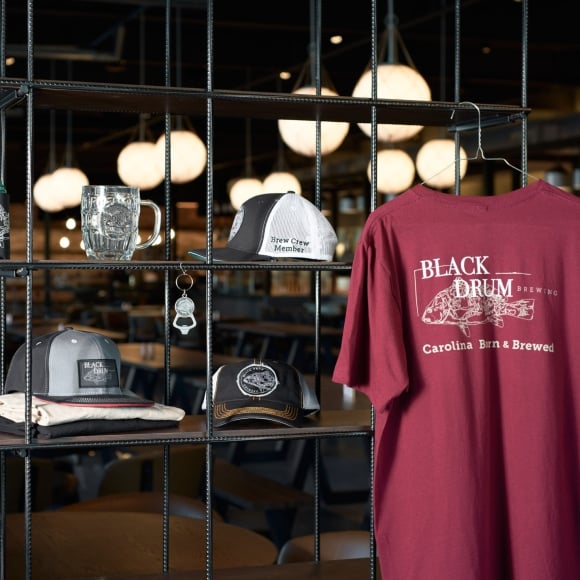 Black Drum Brewing retail for sale. Branded tee shirts, hats, mugs, koozies, and keychain/bottle openers