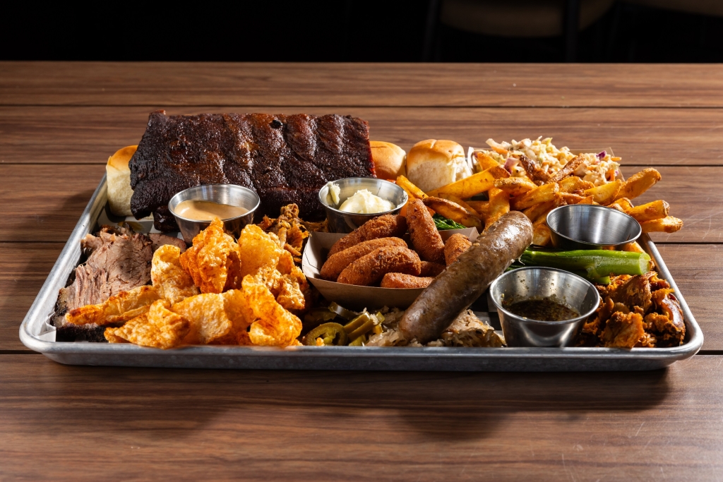 Black Drum Brewing Small BBQ Board consisting of 1/2 rack of ribs, sweet rolls, Cole slaw, French fries, broccolini, pulled chicken, pulled pork, brisket, pork skins, bratwurst, and hush puppies